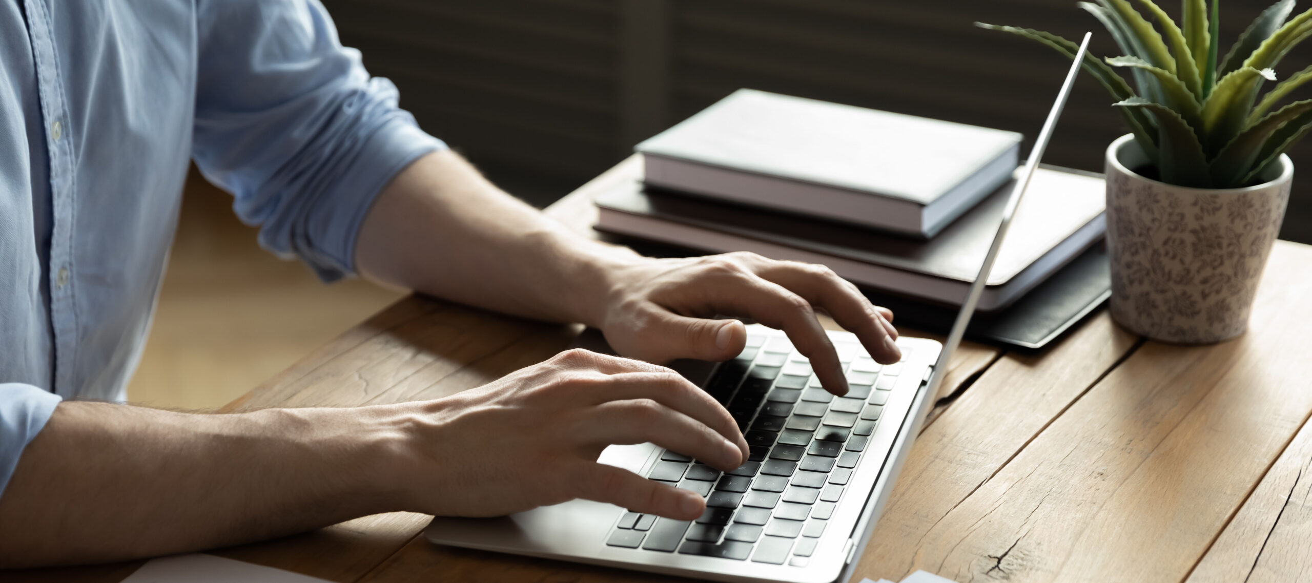 Close up businessman using laptop, sitting at work desk