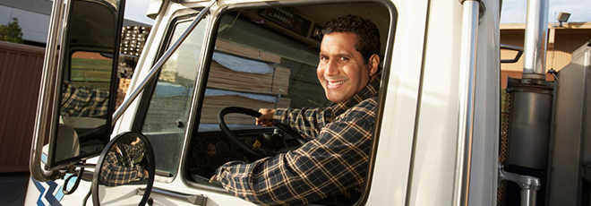 Male truck driver smiling out of the window