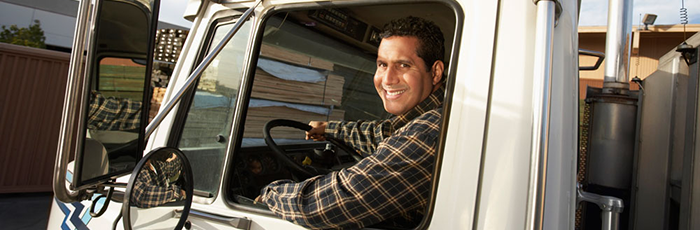 Male truck driver smiling out of the window