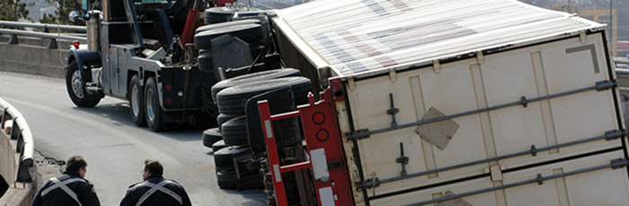 An overturned truck on a bridge