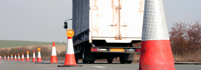 Truck driving past pylons