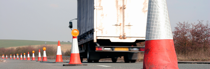 Truck driving past pylons