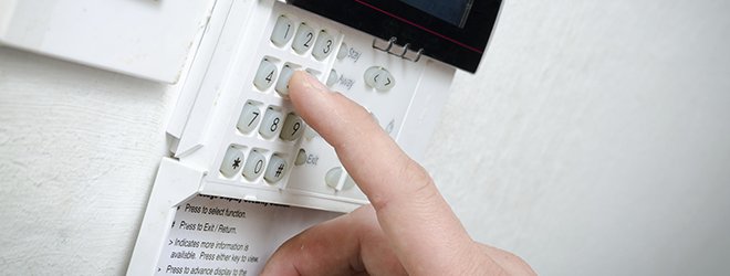 Man setting an alarm system