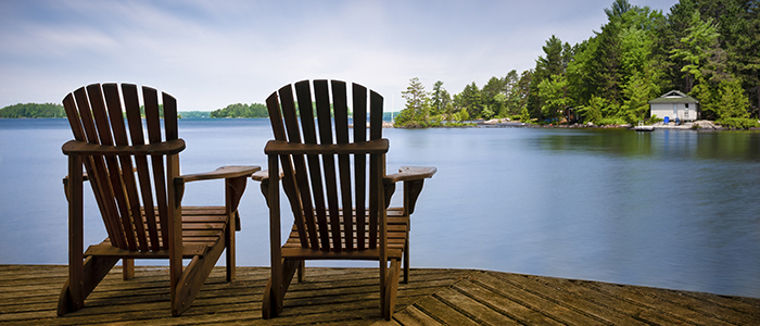 Chairs on a lakeside dock.