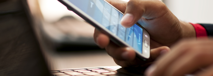 Man using a smartphone and laptop