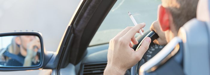 Man with cigarette in car.