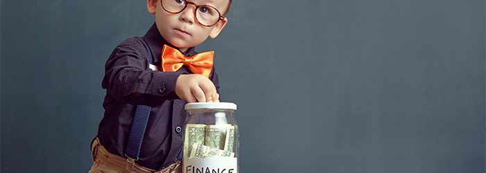 child putting money in a jar