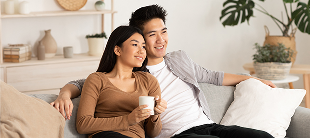 Un jeune couple assis sur un canapé.