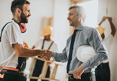 A contractor and surety bondsman shaking hand