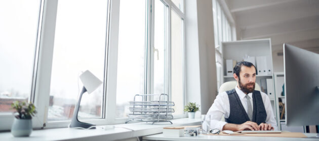 office manager typing on computer keyboard